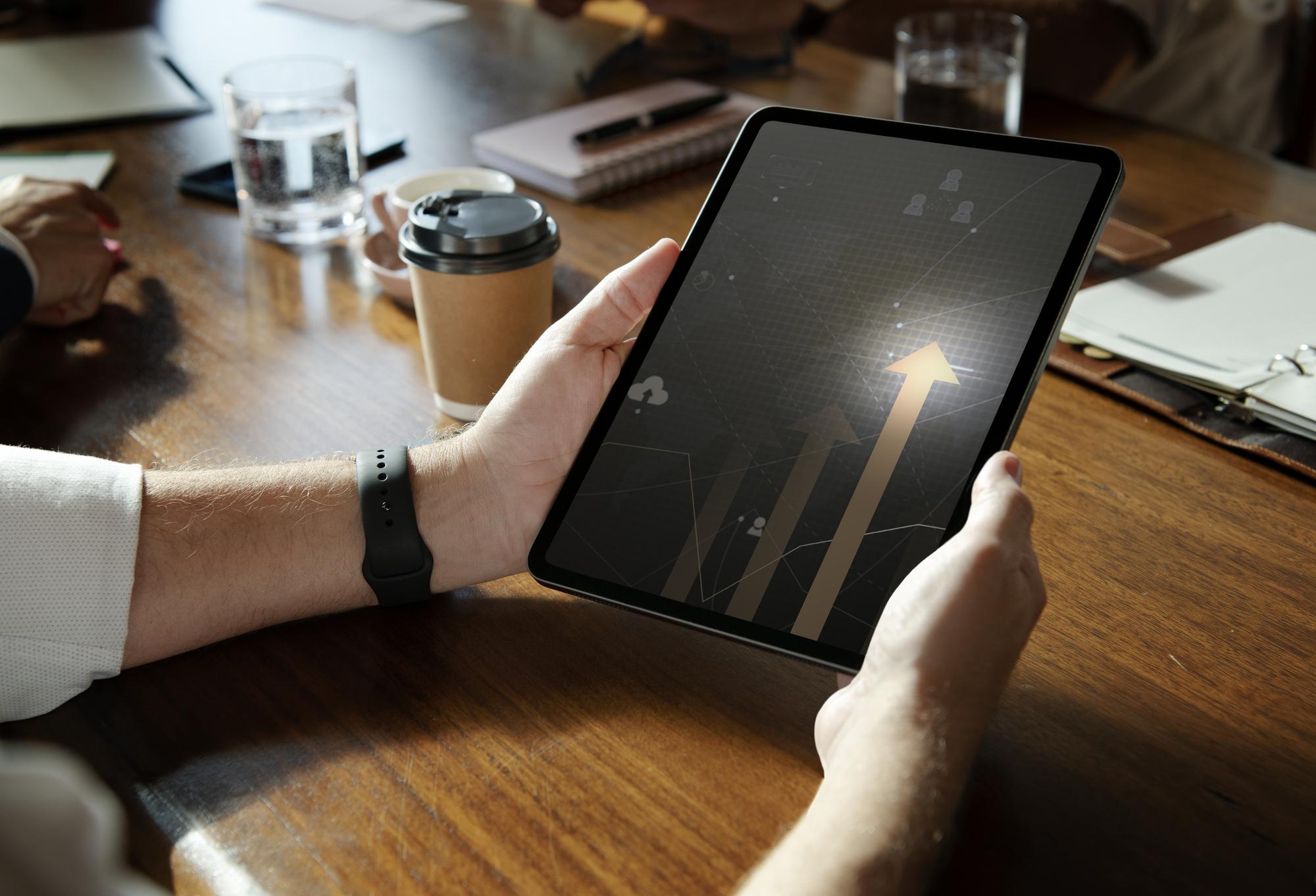 Executive reviewing financial overview on tablet